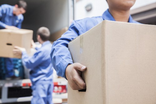 Local movers arranging boxes and furniture during a Lee relocation