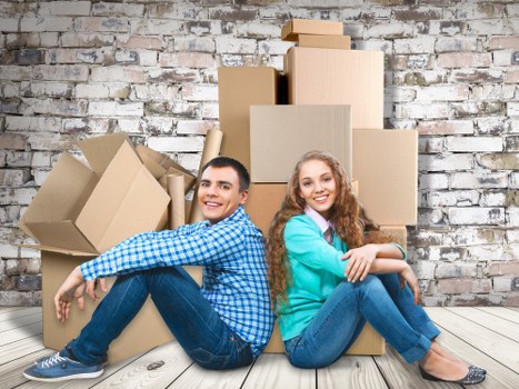 Furniture and boxes being transported by a man with van service