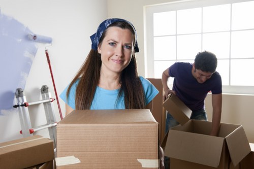 Loading furniture and boxes into a moving truck in Lee