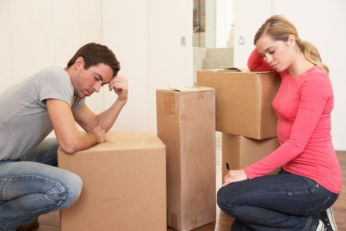 Professional movers loading a van outside a Lee property