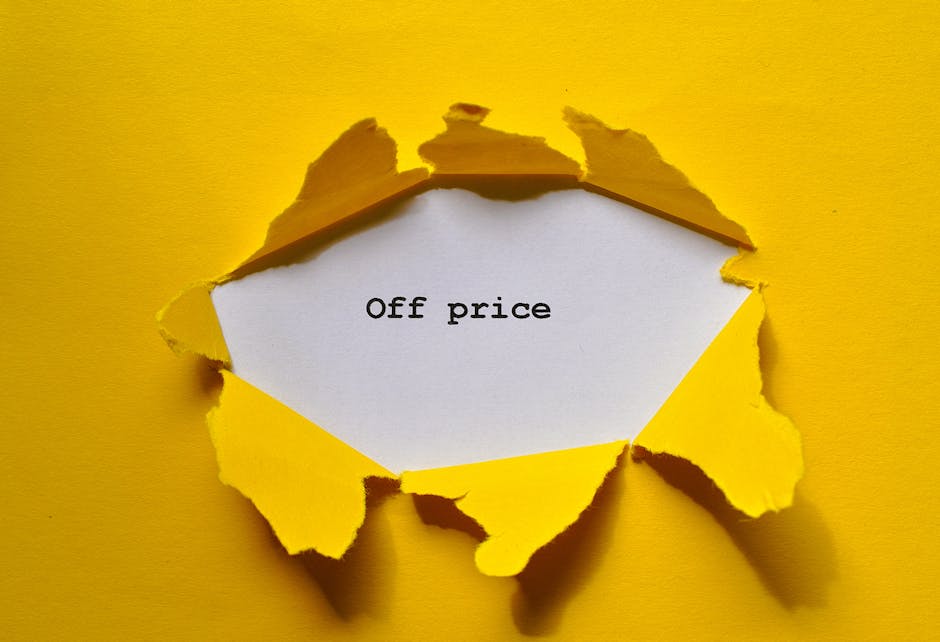 A piece of bright yellow paper with a torn edge revealing a white inner layer, placed against a matching yellow background. The torn section exposes a white card inside with the words 'Off price' typed in black, serif font. The image captures the process of revealing discounted or reduced prices, often associated with clearance sales or special offers, which can relate to moving and packing services by highlighting cost-effective solutions. The lighting is even, emphasizing the torn edges and the contrast between the yellow exterior and white interior, symbolising the uncovering of deals or savings in the context of home relocation and furniture transport services offered by Man With a Van Lee. The scene suggests the theme of price reductions relevant to relocations, home removals, or packing discounts, presented through a simple yet clear visual metaphor.